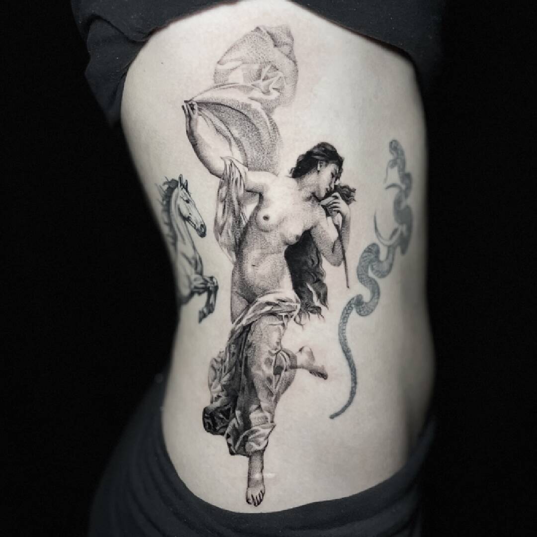 Black and grey tattoo of a dancing figure with serpents, running down the ribs onto the hip.
